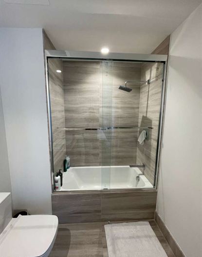 Bypass frameless sliding shower doors in chrome installed in a North Miami home