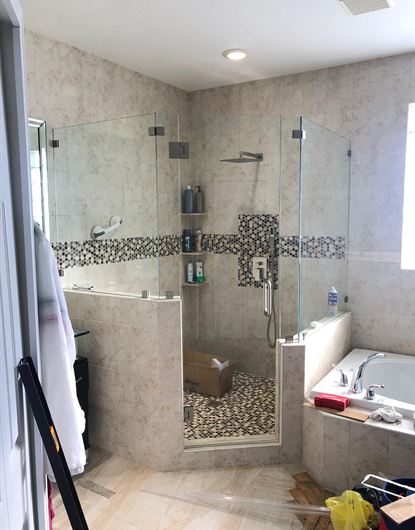 Neo-angle frameless shower door in chrome installed in a Miami-Dade home